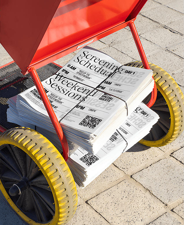 THE RED CHAIR — carrito con programas del festival