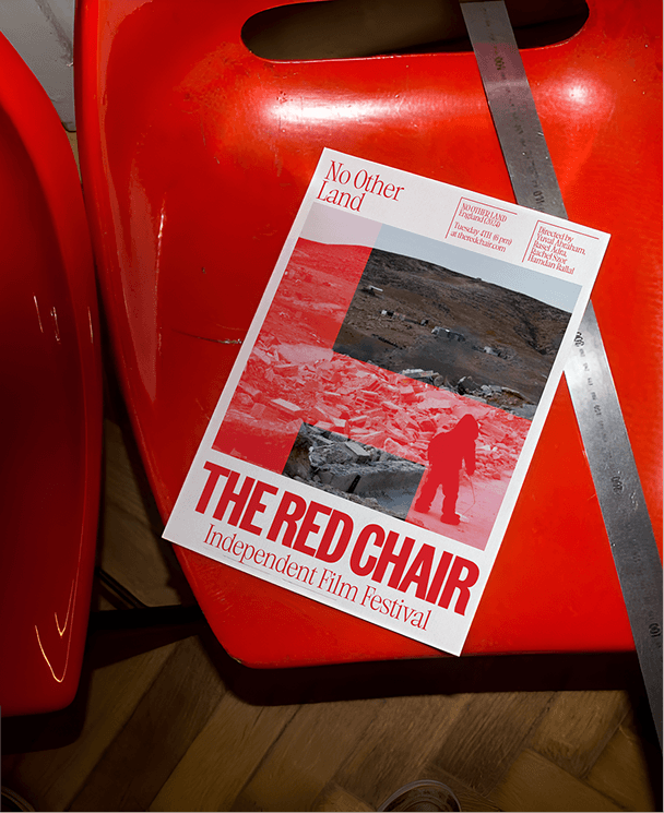 THE RED CHAIR — cartel del festival sobre una silla roja